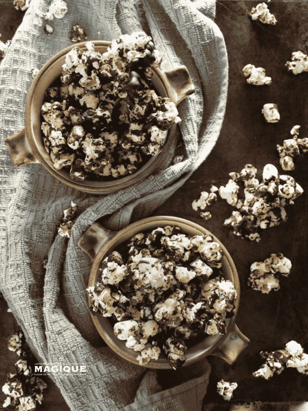 Chocolate-drizzled popcorn with Sel Magique Spicy Blend in warm light
